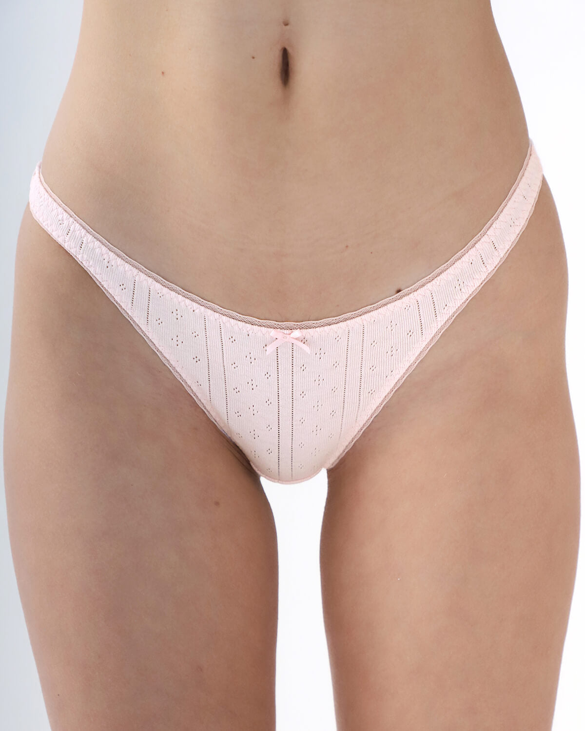 Light pink underwear with subtle pattern on a plain background