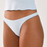 Light blue underwear worn by a person on a neutral background