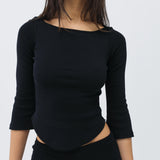 Black long-sleeve top with cut-out design on a plain background