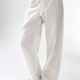 White wide-leg pants worn by a person on a white background