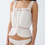 White lace lingerie set on a plain background